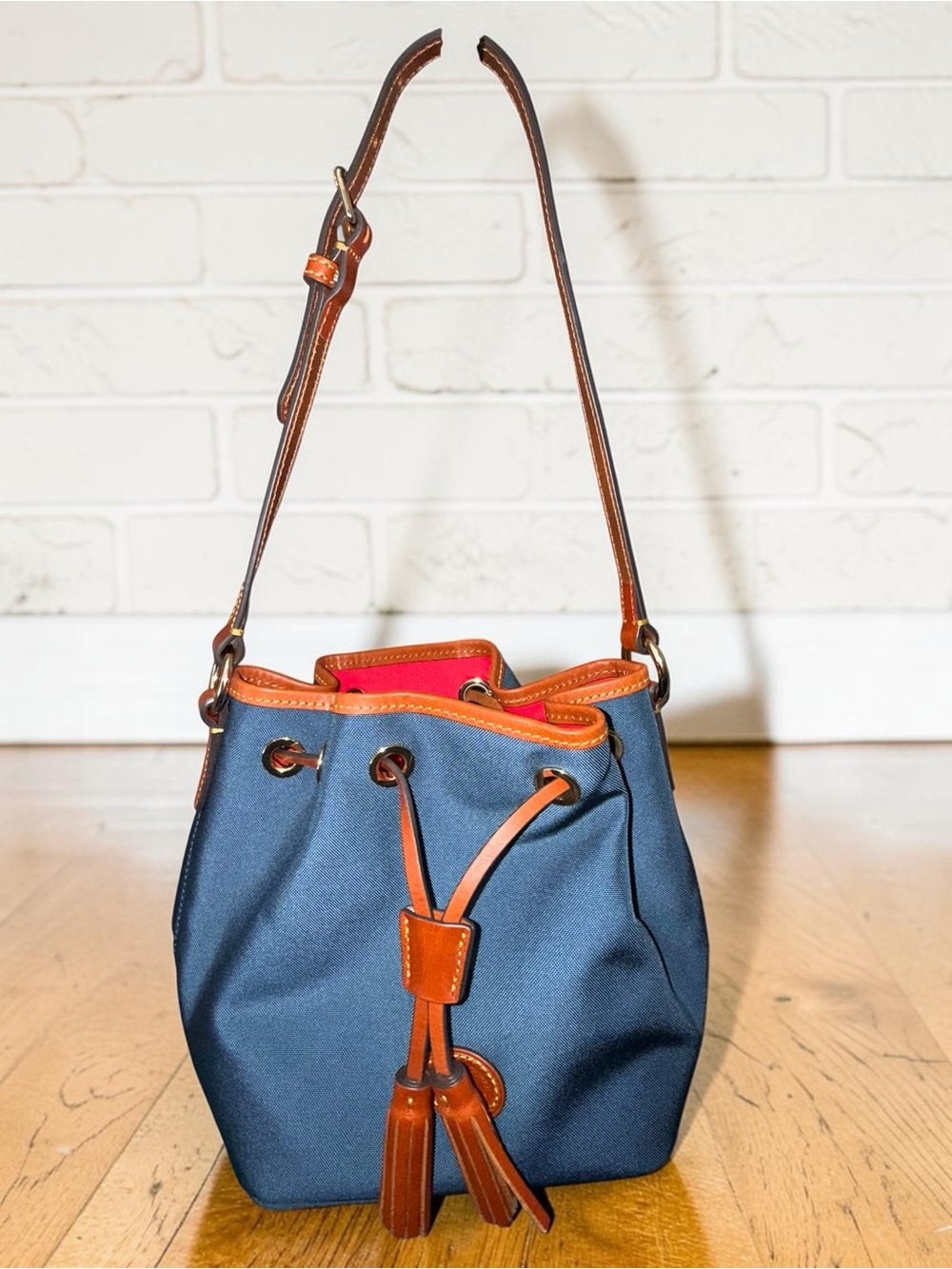 Dooney & Bourke Navy Bucket Drawstring Bag with Tan Trim